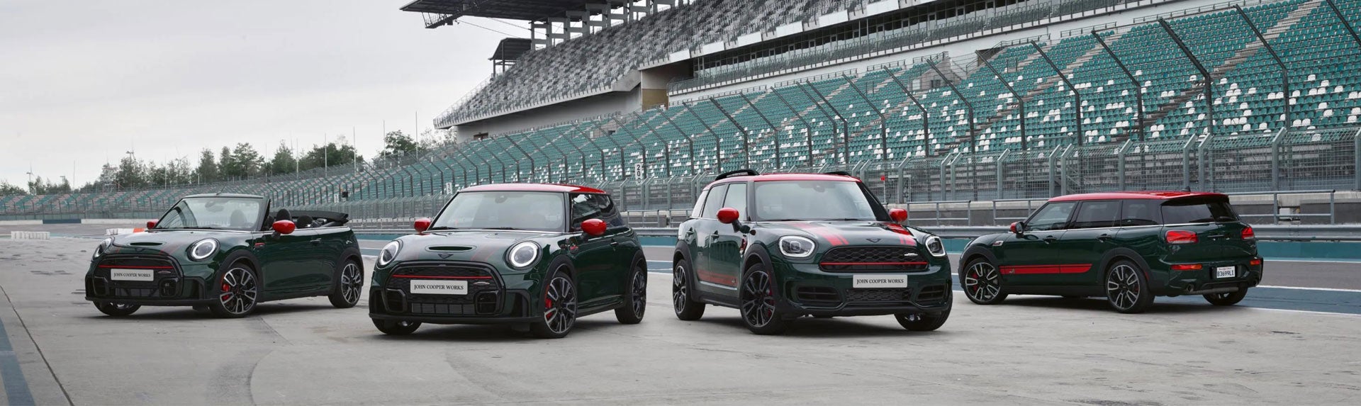 Family of four MINI John Cooper Works models parked on a race track. | MINI of Montgomery County in Gaithersburg MD